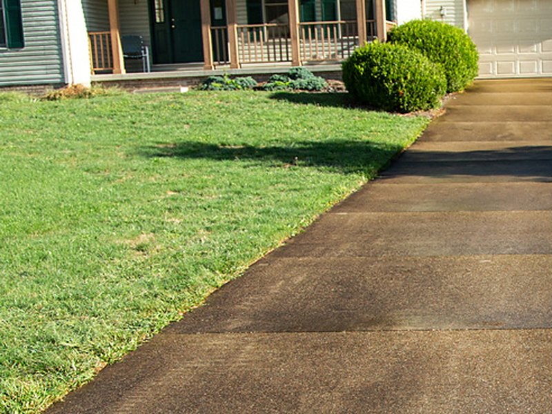 Dark, stained driveway before pressure washing