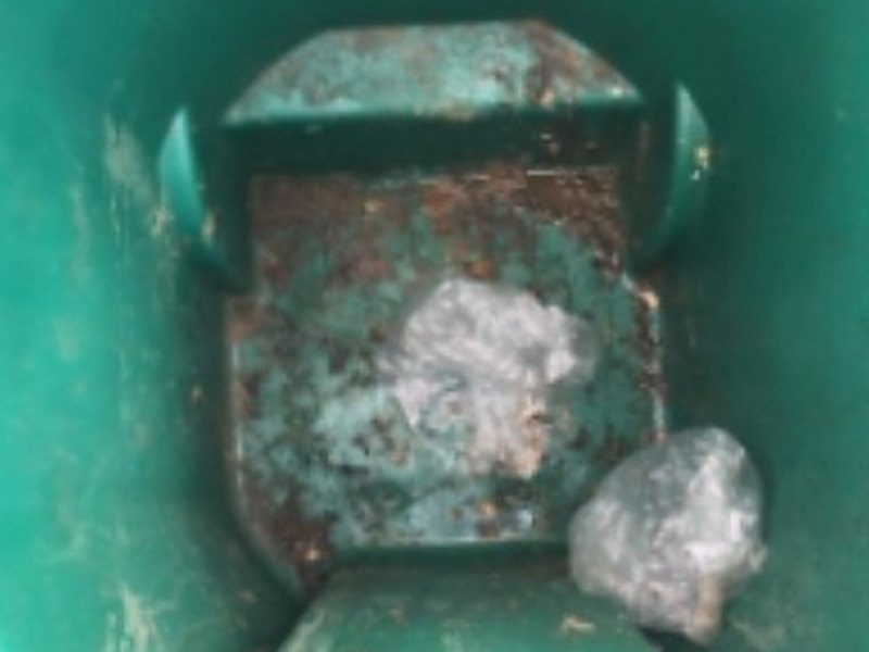 Inside of a dirty trash can before cleaning